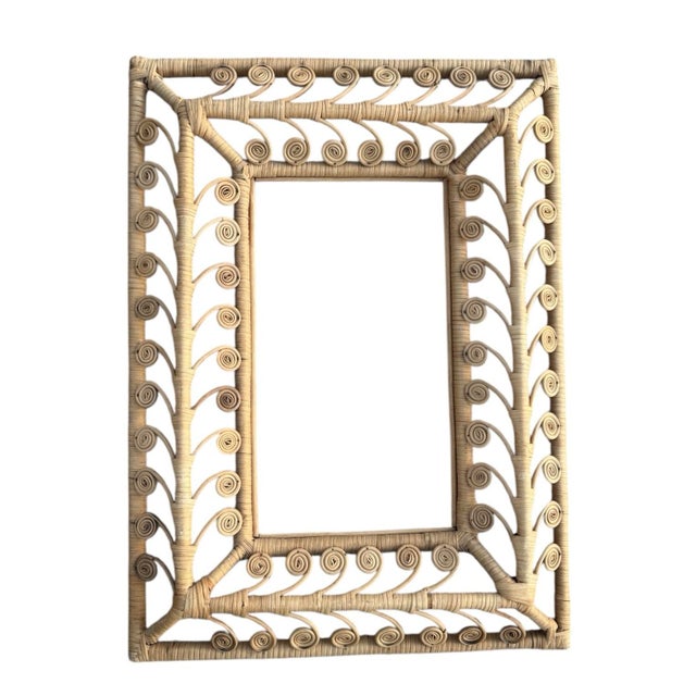 Vintage rattan frame that can be used for pictures or a mirror. Measures 22” wide x 30.5” tall x 2.25” deep