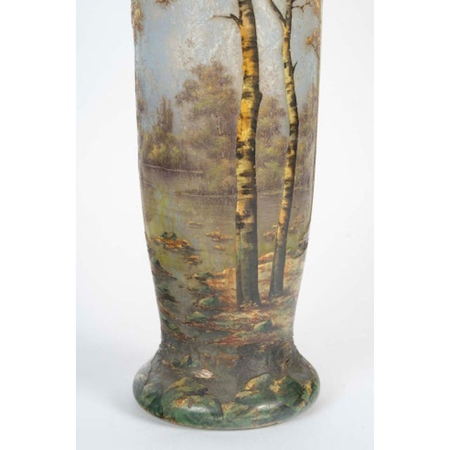 DAUM, Nancy. Important multi-layered glass vase with an acid-etched decoration of a wooded lakeside landscape. Painted...