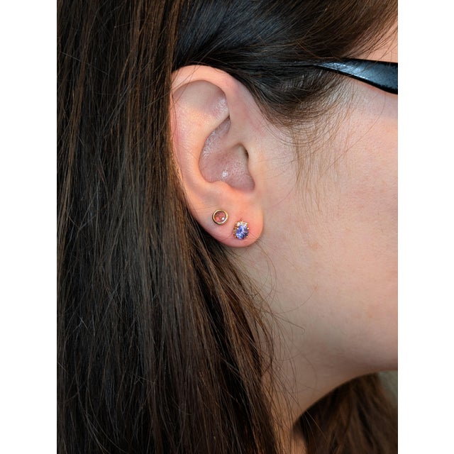 This timeless pair of diamond earring studs feature stunning blue Tanzanite. It is a classic design that is versatile and...