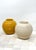 Pair travertine vessels, 1980. Excellent condition and very heavy and solid. Measures 12" tall, 13" diameter, opening 6"...