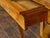 An Austrian Biedermeier period walnut console table from the 19th century, with single drawer, scrolling legs, lion paw...