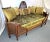 Fabulous antique French cane daybed! This lovely piece is made of double cane in a medium wood tone with a carved wood...