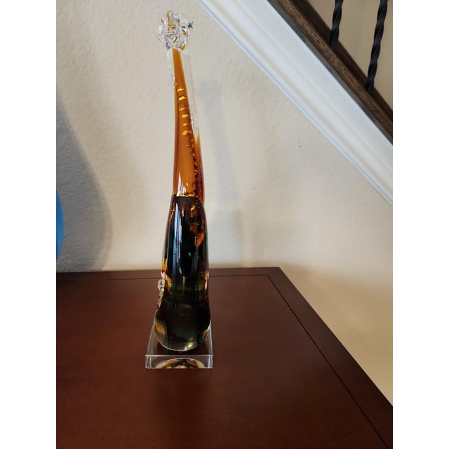 Inject a commanding burst of Mid-Century Modern elegance into your space with this monumental, stylized sommerso giraffe...