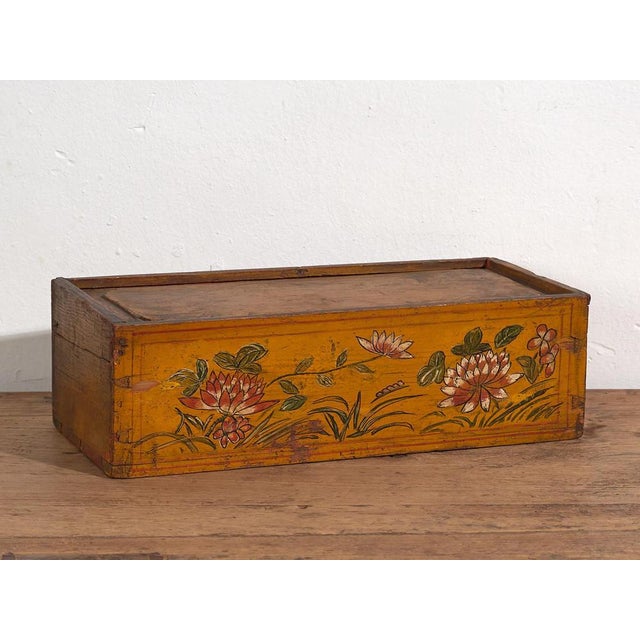 Antique Asian ochre colored box with painted lotus flowers (c.1900) Dimensions: Length: 39 cm Depth: 18 cm Height: 12 cm...