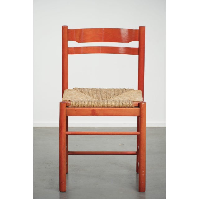 This lovely vintage red chair features a wooden frame and a woven cane seat. It fits easily into almost any interior. The...