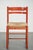 This lovely vintage red chair features a wooden frame and a woven cane seat. It fits easily into almost any interior. The...