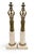 A pair of Neoclassical candlesticks. The figures are modeled, showcasing flowing robes, recalling the form of...