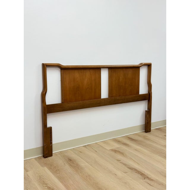 This clean and well-crafted vintage United Furniture mid-century modern solid walnut queen headboard is a timeless and...