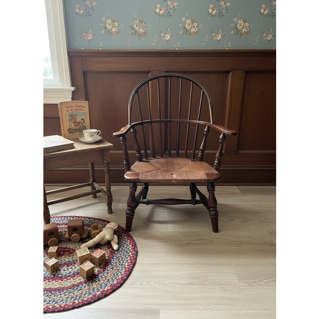 This charming antique child's Windsor armchair was produced by the Paine Furniture Company of Boston, Massachusetts, one...