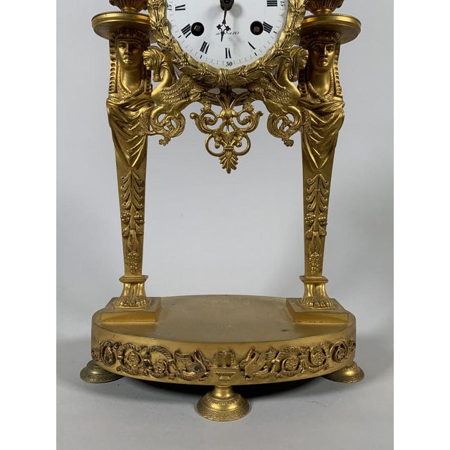 Empire period portico clock, French work, circa 1800. The clock is in the form of a portico framed by two columns...