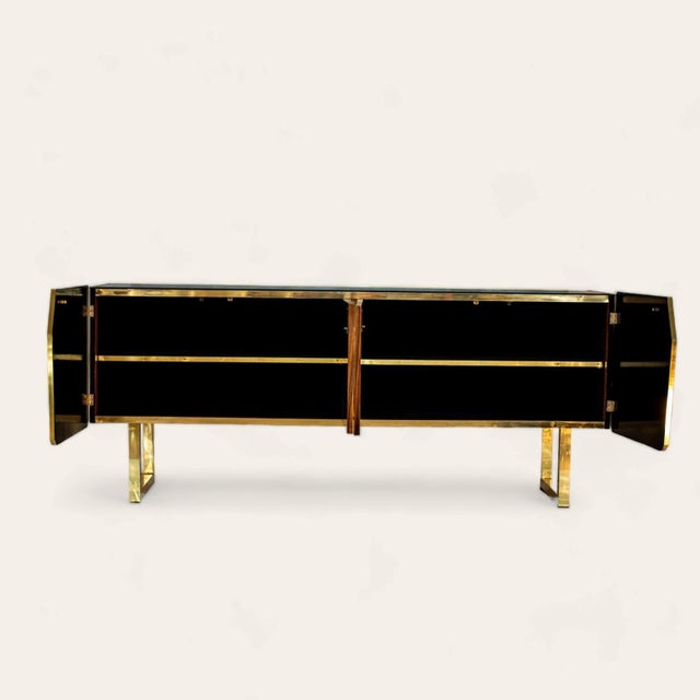 A brass cabinet, inspired by the moon, enchants with its chiseled surface, rich in craters and curves evoking the lunar...