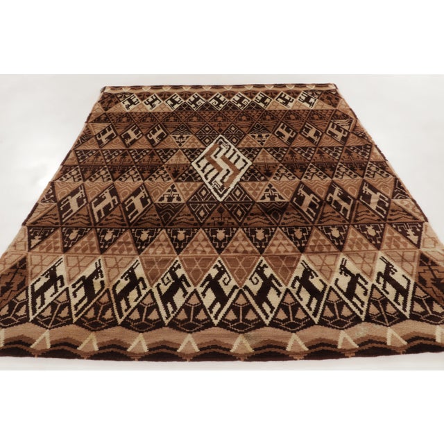 Hand-knotted in wool, this 8x10 vintage French rug, circa 1950–1959, features rhythmic geometric bands enriched with human...