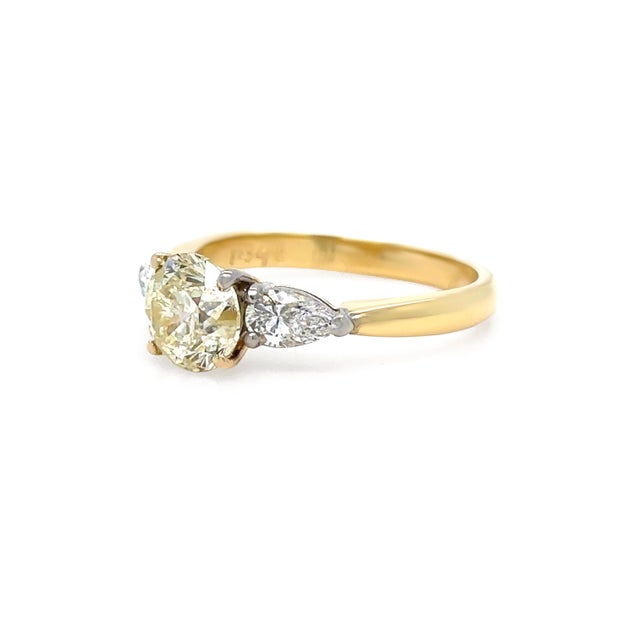 A striking diamond engagement ring crafted in 18ct yellow and white gold, featuring a substantial round brilliant cut...