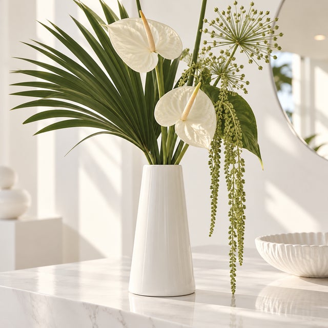A vintage, ceramic vase with a tall, tapered form and white glaze. Good condition.