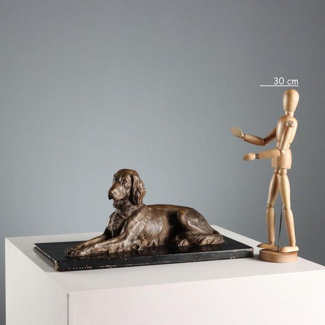 Terracotta dog on a black patinated wooden base. Engraved signature of the artist. This piece is attributed to the...