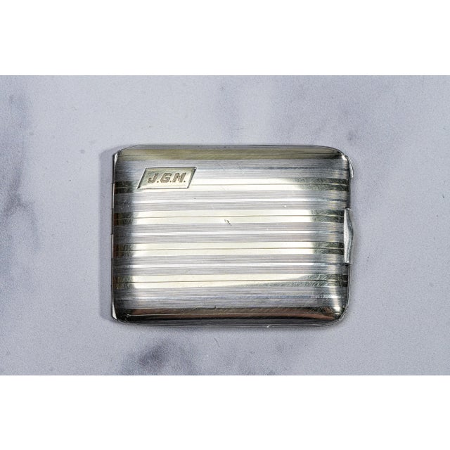 A striking example of refined American silverwork, this engine-turned matchbook holder by Gorham embodies understated...