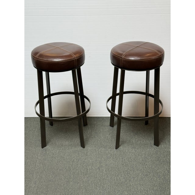 Design Plus Gallery presents a Pair of the Bon Bon Swivel Barstools from Berman Rosetti. Each stool has a round leather...