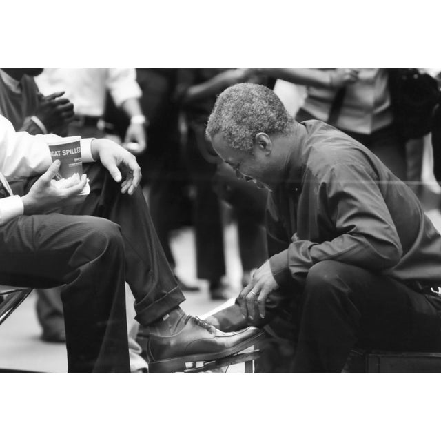 Artist: Drew Doggett Title: Shoeshine Medium: Archival Pigment Print, signed on the matting Size: 20 x 23 inches Framed...