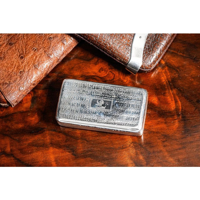 A distinguished example of English craftsmanship, this antique sterling silver table snuff box captures the refinement and...