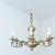 A French silver-gilded brass chandelier with a unique aged patina. The curved forms and undulating lines of this fixture...