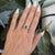 A natural purple sapphire glows at the heart of this oval ring, wrapped in a brilliant halo of diamonds and set in solid...