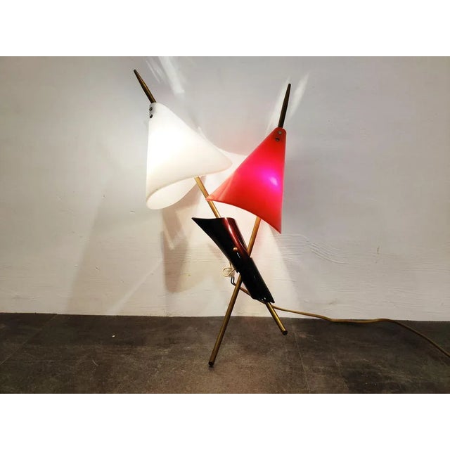 Mid-Century Italian wall light with a white and red acrylic lamp shade and brass arms. Attributed to Stilnovo, not...