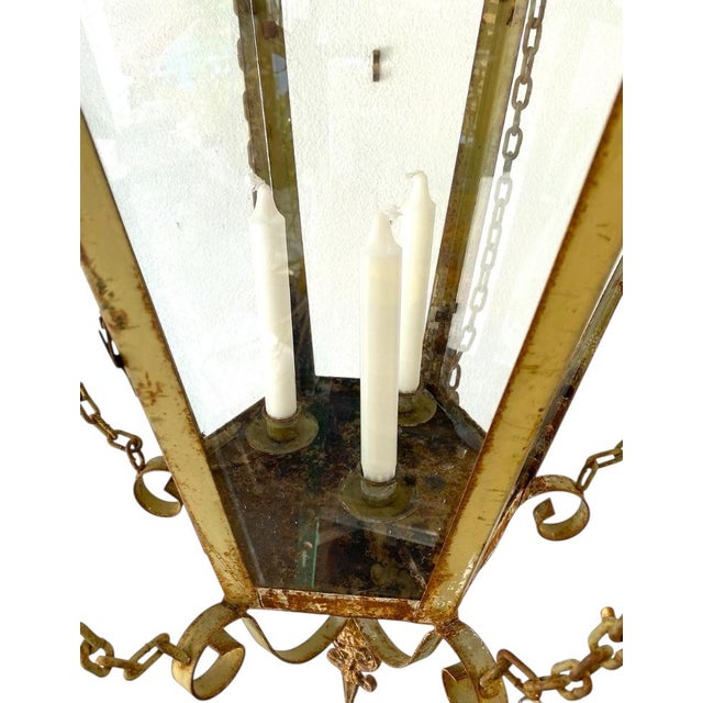 Fabulous, large vintage, metal and glass hanging 3 candle lantern, with a great old painted patina. The lantern is in...