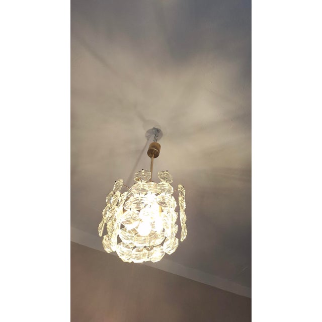 Kinkeldey chandelier in brass from the 1960s with 3 levels of faceted glass crystals cut in octagonal shapes hanging from...