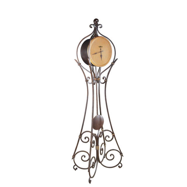 The case is metal and is finished in Aged Ironstone with burnished gold accents. The matching pendulum bob is clearly...