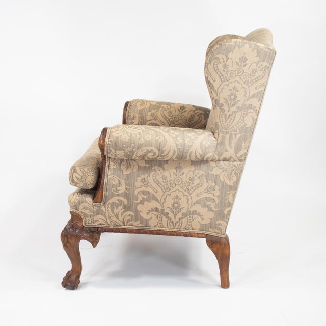 This George II Chippendale-style wing armchair is an example of bench-made craftsmanship from the renowned Chicago design...