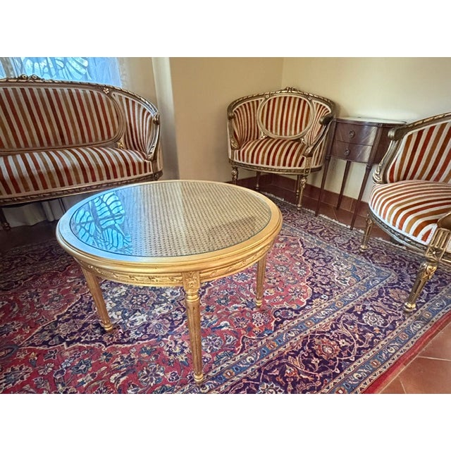 This suite of French Louis XIV Antiques consists of a hand carved and gilded sette, two side chairs and a small 28" round...