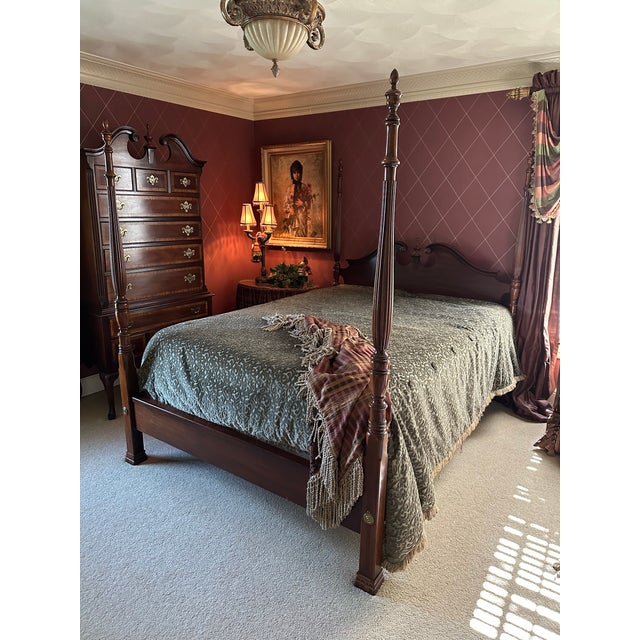 A Chippendale style queen size 4 poster bed by Dixie Furniture. Mahogany with carved pediment top to headboard & center...