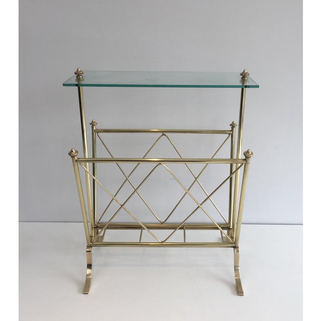 This very beautiful and elegant neoclassical style magazine rack is made of brass with a glass top. It is a French work by...