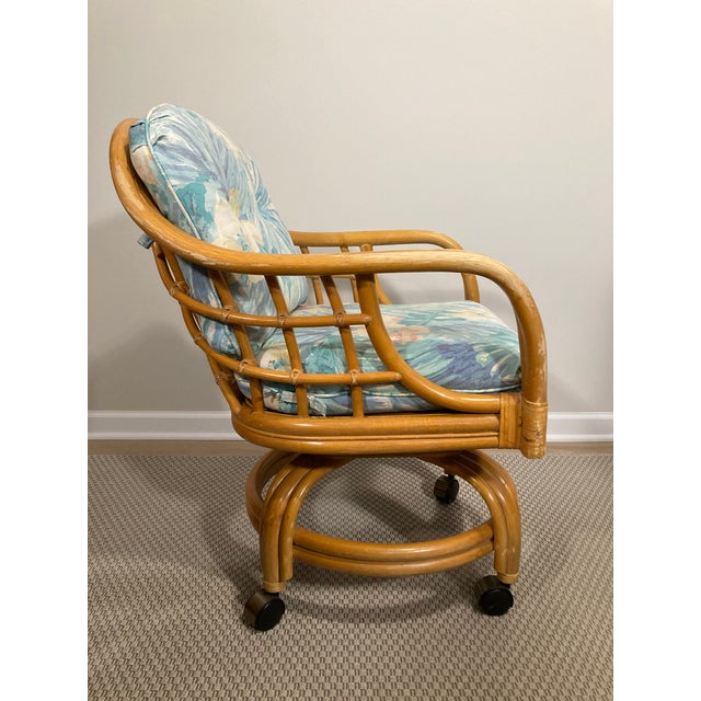 With sculpted bamboo lines these vintage barrel-style arm chairs are full of Palm Beach charm. The pastel floral fabric is...