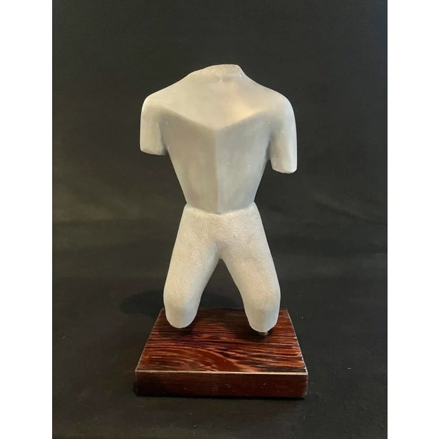 Cubist style, chiseled technic and hand carved sculpture of a male torso standing on a hardwood base. Signed and dated...