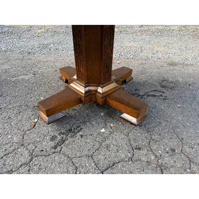 Antique Hand carved Tiger oak pedestal base dining table. It features Splayed Feet, hand carved fretwork 2 leaves Sturdy...