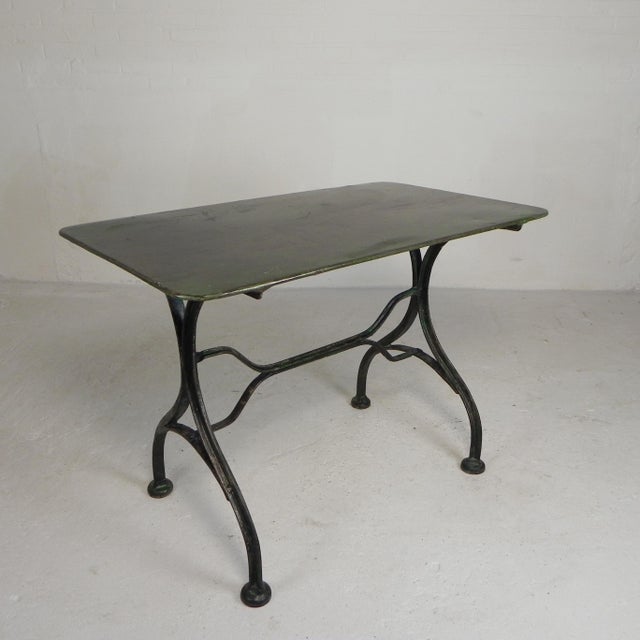 This table, which was used by a French café for many years, is in good condition. The steel is clear lacquered. Height: 71...