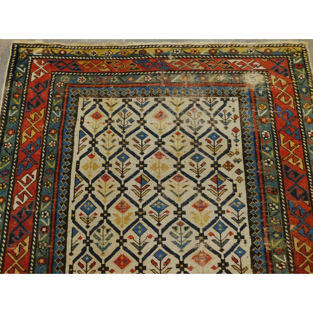 Distressed Antique hand knotted Caucasian rug. Trellis pattern decorated with geometric flowers. Material: wool. Size: 5'x...