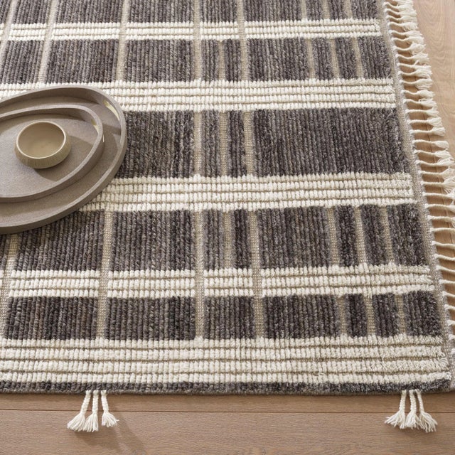 Underlying harmonies of sumptuous surfaces and calming tones are found in this luxurious hand-knotted wool rug. Tufty...