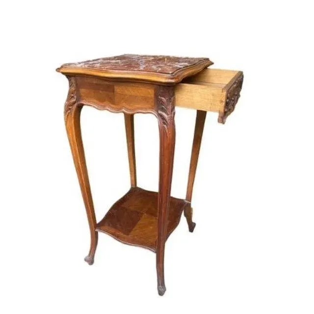 A late 19th century Louis style side table with marble top. Measures 18.5"W x 17.5"D x 32.25"H. Note a small marble...