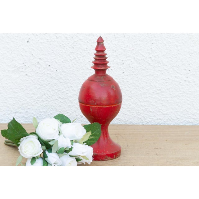 A captivating piece of devotional carpentry, this turned wooden container is shaped like an architectural finial or temple...