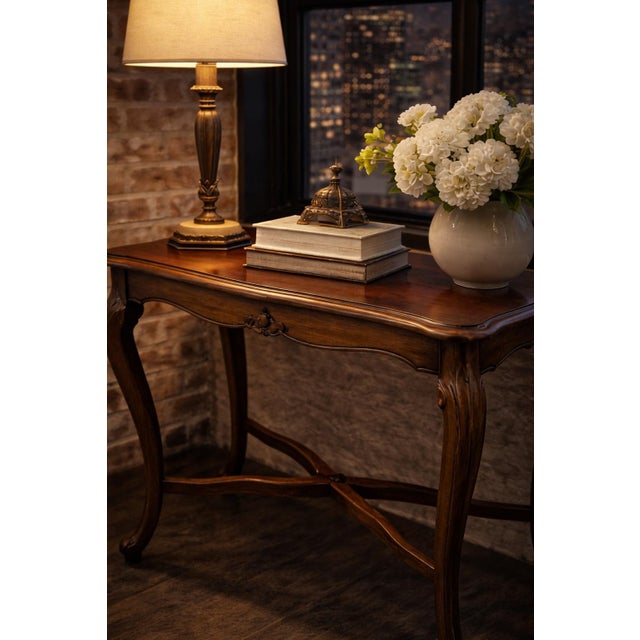 An elegant French Provincial side table featuring a serpentine top, carved cabriole legs, and a rich Old Chapel Satin...