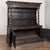 18th century German display cabinet, crafted in oak with extensive hand carved detail and a dark aged patina. The crown is...