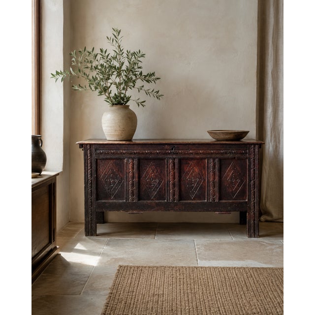 A wonderfully atmospheric late 17th-century English oak coffer, dating to circa 1680, with a richly carved four-panel...