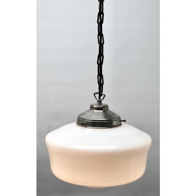 From the range by the Phillips Company, this center-light on a central chain. The lamp has a fitting on a chromed plate...