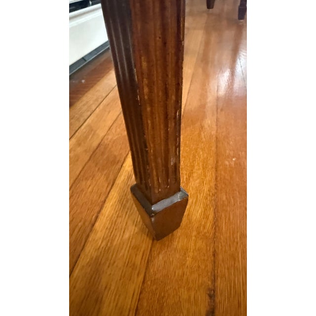 A finely crafted Maitland Smith console table in the English Adam style, distinguished by its serpentine front and richly...