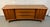 Beautiful vintage Mid-Century Modern dresser featuring a striking sculpted wave-front design and warm walnut wood grain....