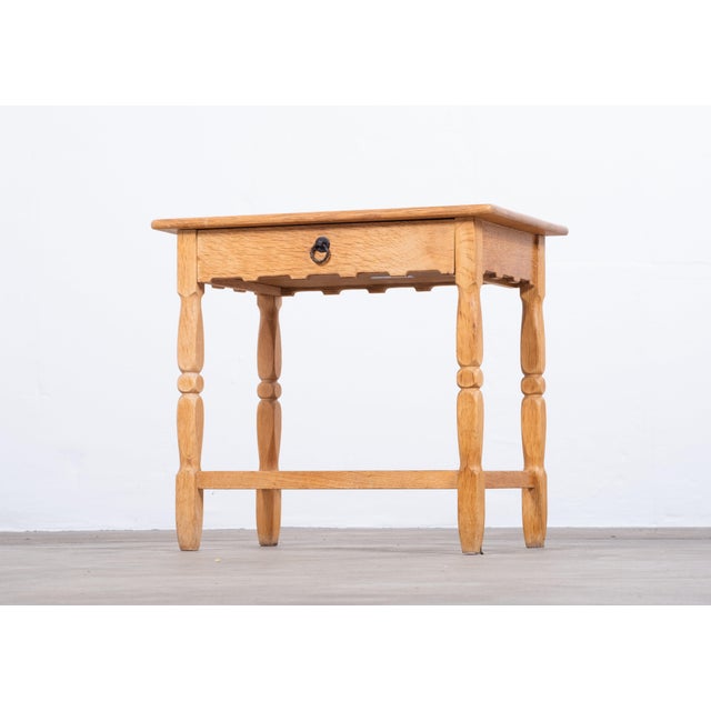 Striking Danish brutalist oak side table from the 1960s, featuring a sculptural design in the style of Henning Kjærnulf....