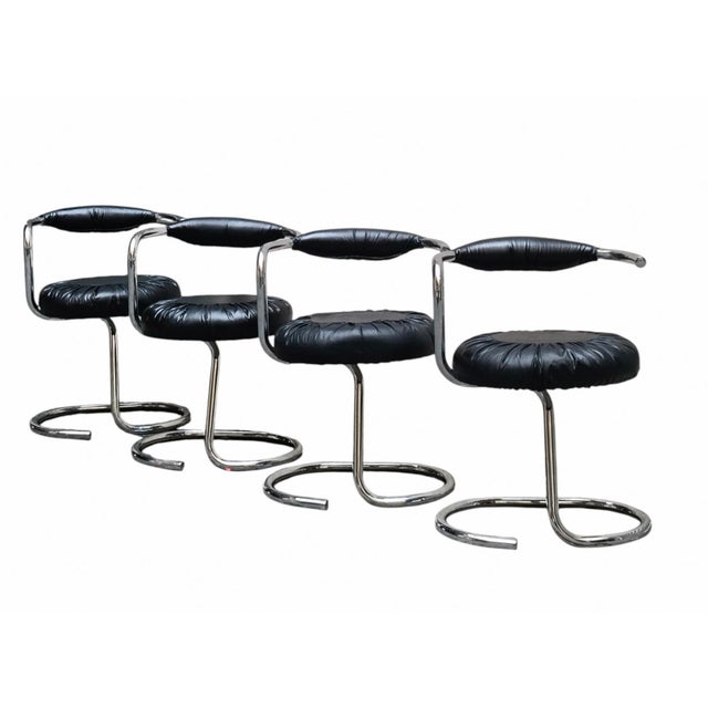 A beautiful set of four black “Cobra” chairs designed by Giotto Stoppino in the 1970s. The chairs feature a tubular...