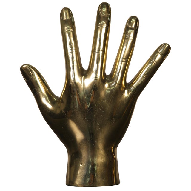 An open hand is rendered simply in an expertly weathered warm antique finish. Featuring raw, stylized lines, this...